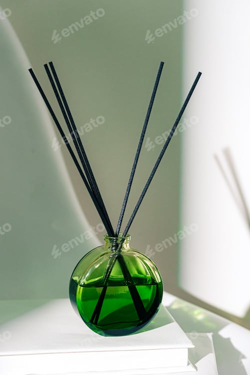 Preview: Liquid home perfume in glass diffuser with sticks on chair