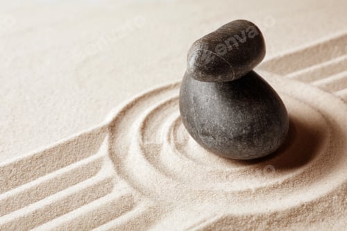 Preview: Stacked zen garden stones on sand with pattern, space for text. Meditation and harmony