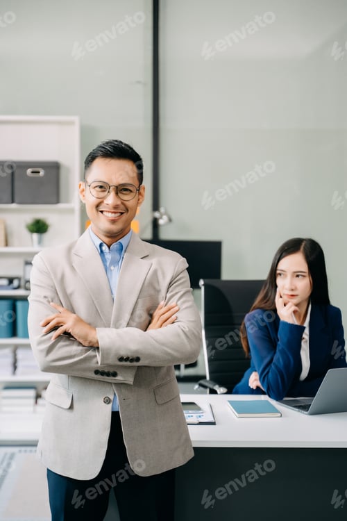 Preview: Young attractive Asian male office worker business suits smiling at camera in office
