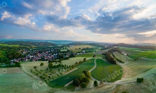 Preview: Panorama of a village with streets and buildings, spring trees against the background of cloudy sky