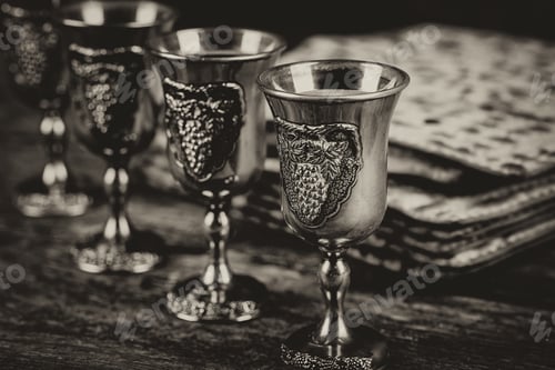 Preview: Red kosher four glasses wine with a of matzah a Passover Haggadah on a vintage wood background
