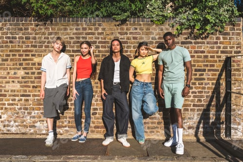 Preview: Multiracial group of happy young friends bonding in London