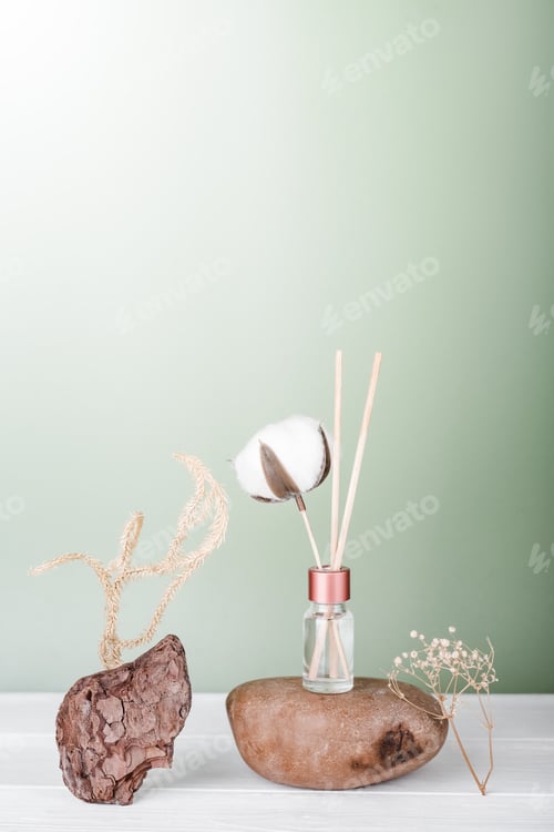 Preview: hygge and aromatherapy concept. aroma reed diffuser, cotton bud on white table