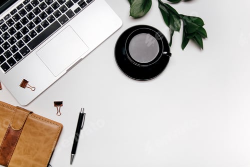 Laptop Coffee Cup and Planner on Desk