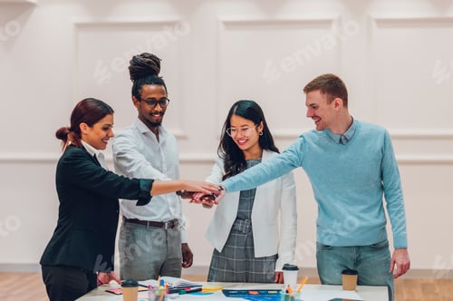 Preview: Multiracial business team having a meeting in office and celebrating victory