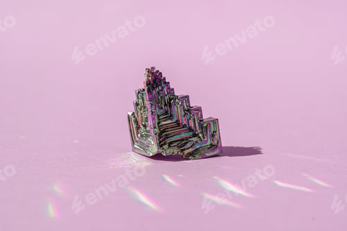 Preview: Synthetic bismuth Bismuthum crystal with iridescent oxide film on pink background close up isolated