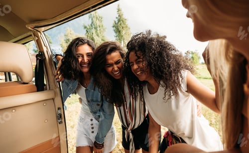 Preview: Young people standing together and having fun at minivan door