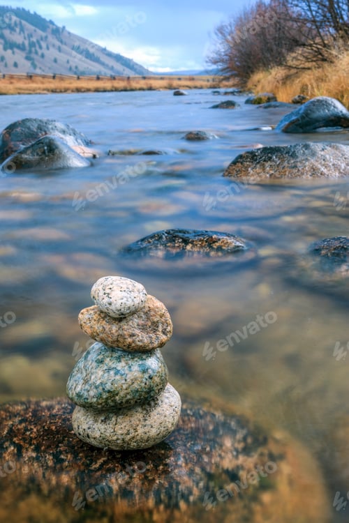 Preview: Closeup of stacked rocks in river.