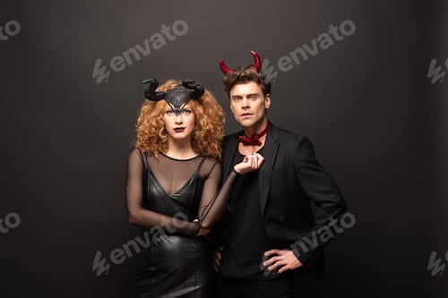 Preview: beautiful couple posing in halloween costumes on black