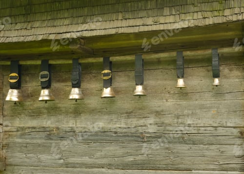 Rustic Wooden Wall Displaying Antique Cow Bells