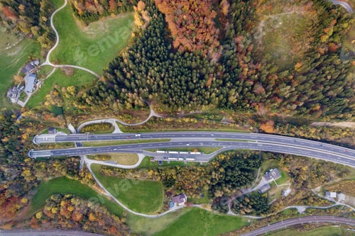 Preview: Top dawn aerial view of freeway speed road going out from undeground tunnel