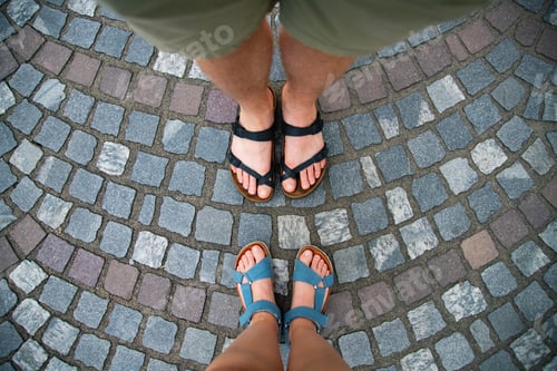 Preview: Legs of couple on cobblestone street.Travel, holiday concept.