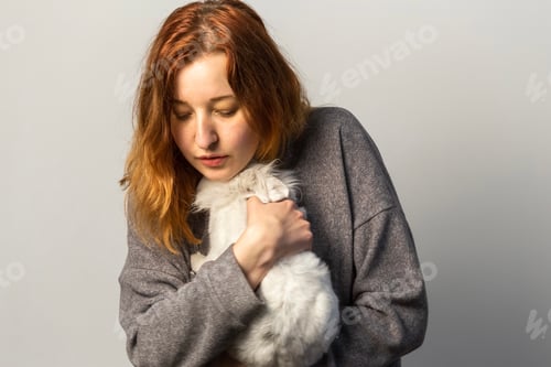 Preview: Young woman hugging a bunny pet. Animal therapy and pet care concept