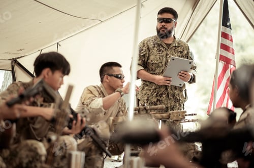 Preview: Soldiers in camouflage uniforms planning on operation in the camp