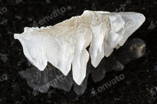 Preview: sample of rough salammoniac rock on black granite