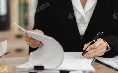 Preview: Professional Female Lawyer Reviewing Contract Documents for Legal Case in Office Setting
