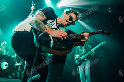 Preview: Guitarist performing energetically on stage during concert