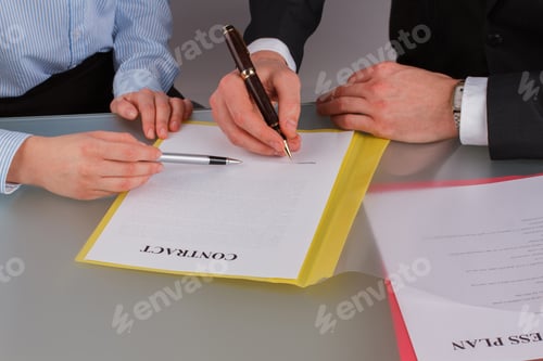 Preview: Business people discussing business contract.