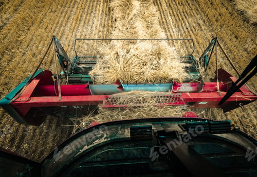 Preview: Combine harvester driver's POV while threshing wheat in an agricultural field