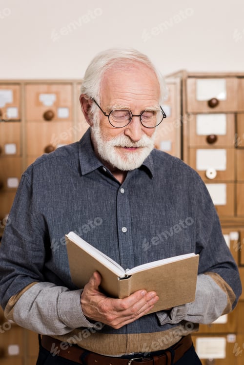 Preview: senior male archivist reading book