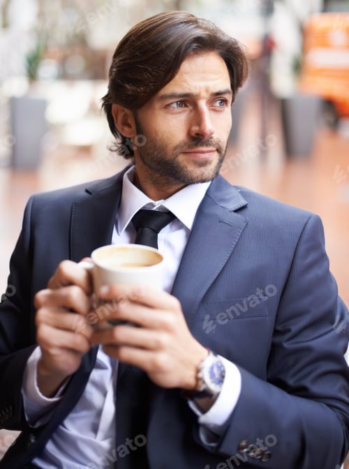 Preview: A thoughtful businessman drinking coffee outdoors at a coffee shop