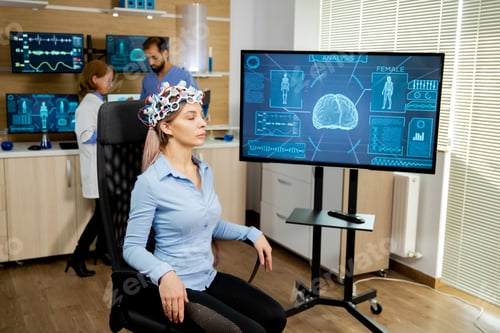 Preview: Patient woman with head scanning device and brain activity is seen on screen
