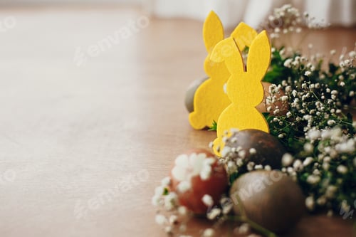 Preview: Stylish easter eggs and yellow bunny on rustic wooden table