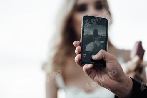 Preview: Happy authentic candid married couple in love take selfie for social media outdoor