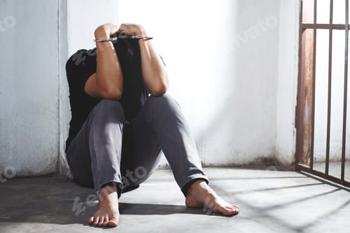 Preview: The prisoner is sitting in his cell and desperate, holding his head in his hands.