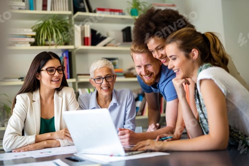 Preview: Group of happy business people discussing and working together during a meeting in office