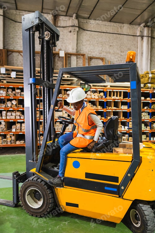 Preview: Worker entering forklift in a timber warehouse
