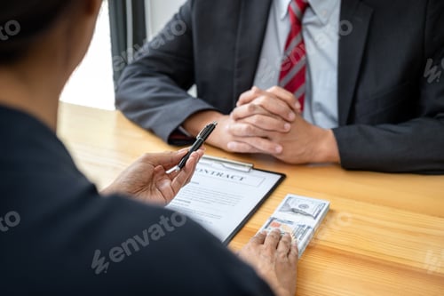 Preview: Bribe employer is handing over a pen and offer terms to businessman for signing on contract