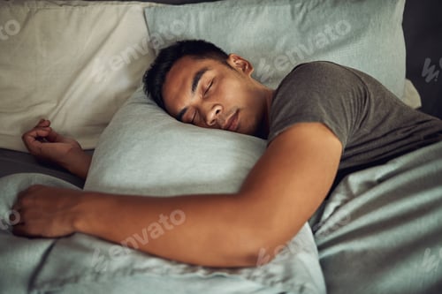 Preview: Nothing soothes the soul like a deep sleep. Shot of a young man sleeping peacefully in bed at home.