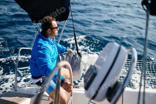 Preview: Handsome strong man sailing with his boat