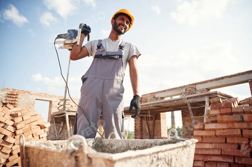 Preview: Cheerful and handsome Indian man is on the construction site