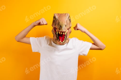 Preview: Teenager with T-Rex mask on yellow background