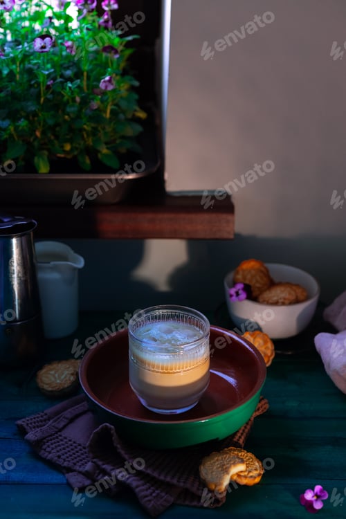 Preview: coffee in transparent cup with homemade cookies - selfish breakfast. Green wooden table with pansies