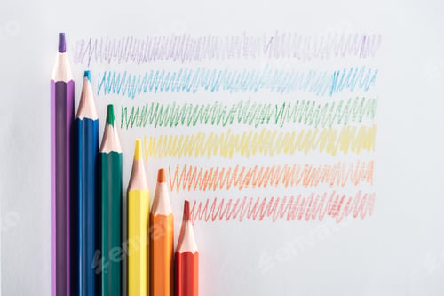 Preview: top view of rainbow multicolored pencils and strokes on grey background, lgbt concept
