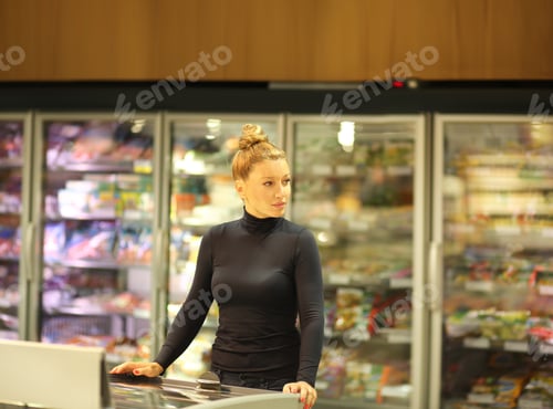 Preview: Woman Choosing Frozen Food From A Supermarket Freezer