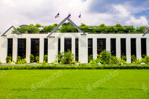 Preview: Asia botanic garden building exterior and green grass lawn with plant and flags on roof top