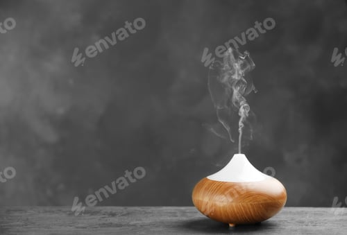 Preview: Aroma oil diffuser on table against grey background. Air freshener
