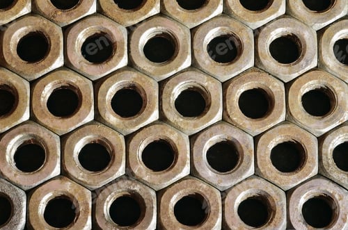 Preview: Closeup of a pile of rusty nuts. Retro industrial concept
