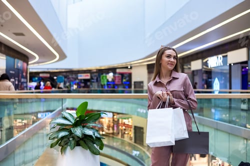Preview: Woman Enjoying a Shopping Spree in a Modern, Vibrant Mall During an Afternoon Outing