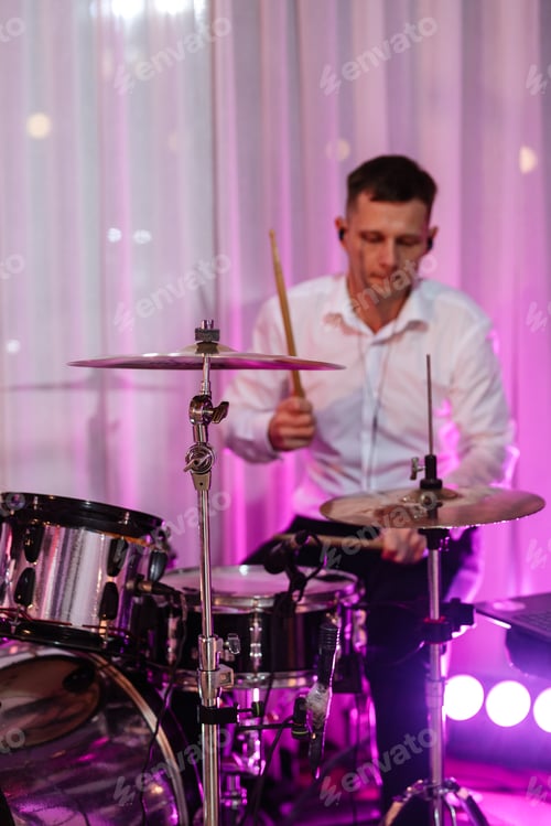 Preview: guy musician plays the drum at a concert