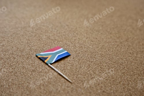 Preview: Closeup shot of the flag of South Africa on a brown surface