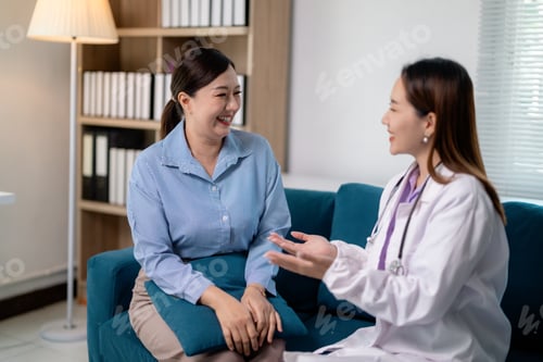 Preview: Doctor and patient talking and smiling during a medical consultation in a clinic