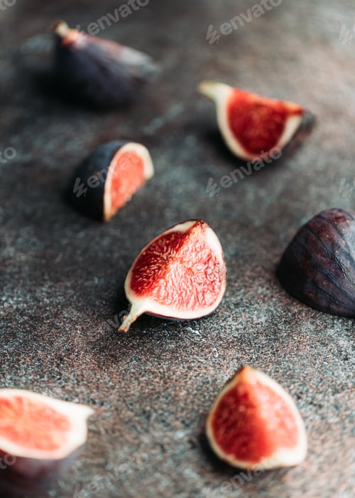 Preview: Macro photography of fresh ripe cutted figs on the textured background.