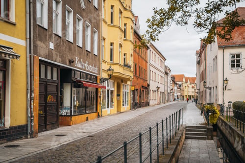 Preview: Charming European street with colorful buildings and cobblestone pavement on a cloudy day