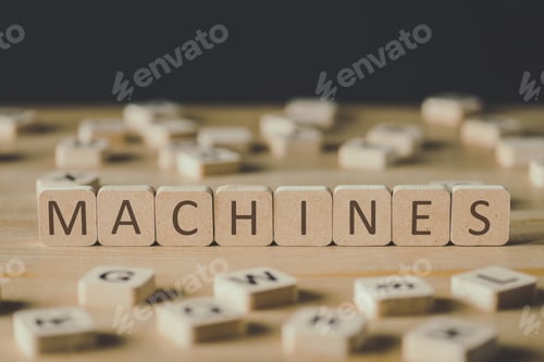 Preview: selective focus of machines lettering on cubes surrounded by blocks with letters on wooden surface