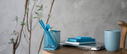 Preview: Pencil holder, notebook, coffee cup and laptop on wooden table.